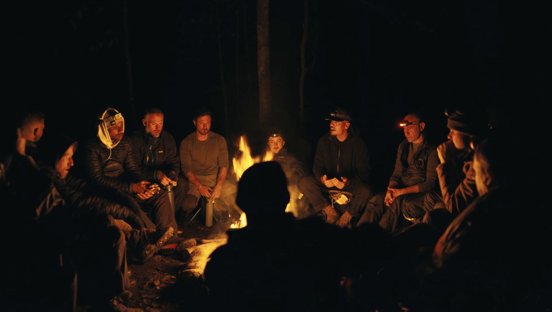 Men gathered around a fire at night