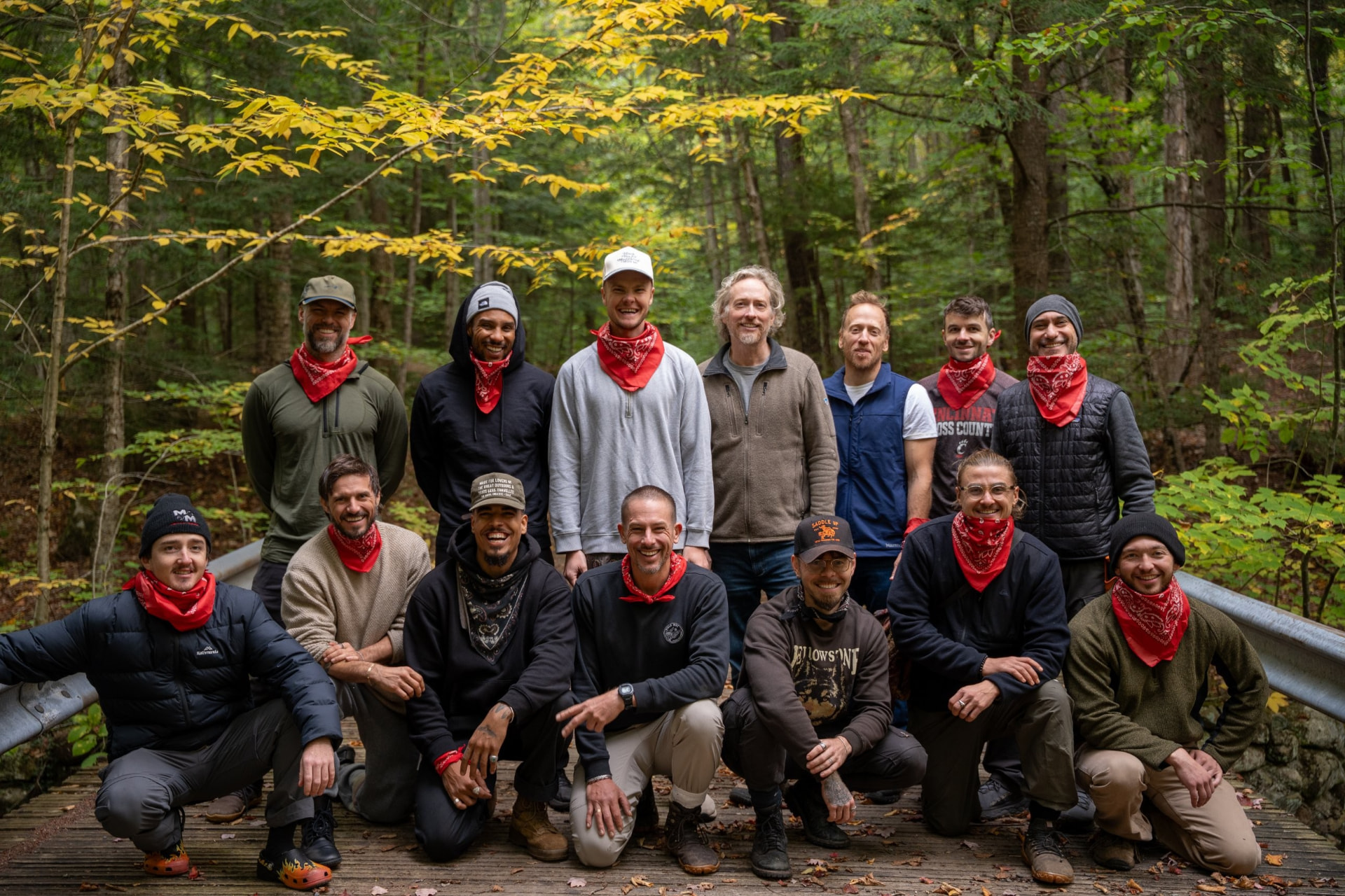 Men together in two rows in the forest